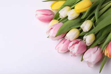 Beautiful colorful tulips on light background, closeup. Space for text