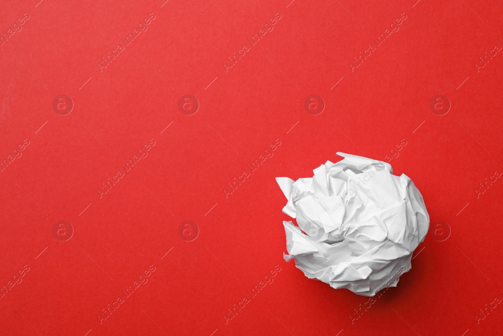 Photo of Crumpled sheet of paper on color background, top view. Space for text
