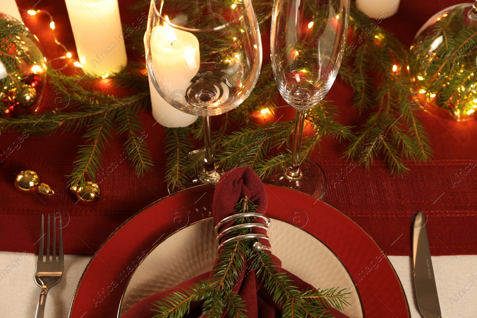 Photo of Christmas place setting with festive decor on table, closeup