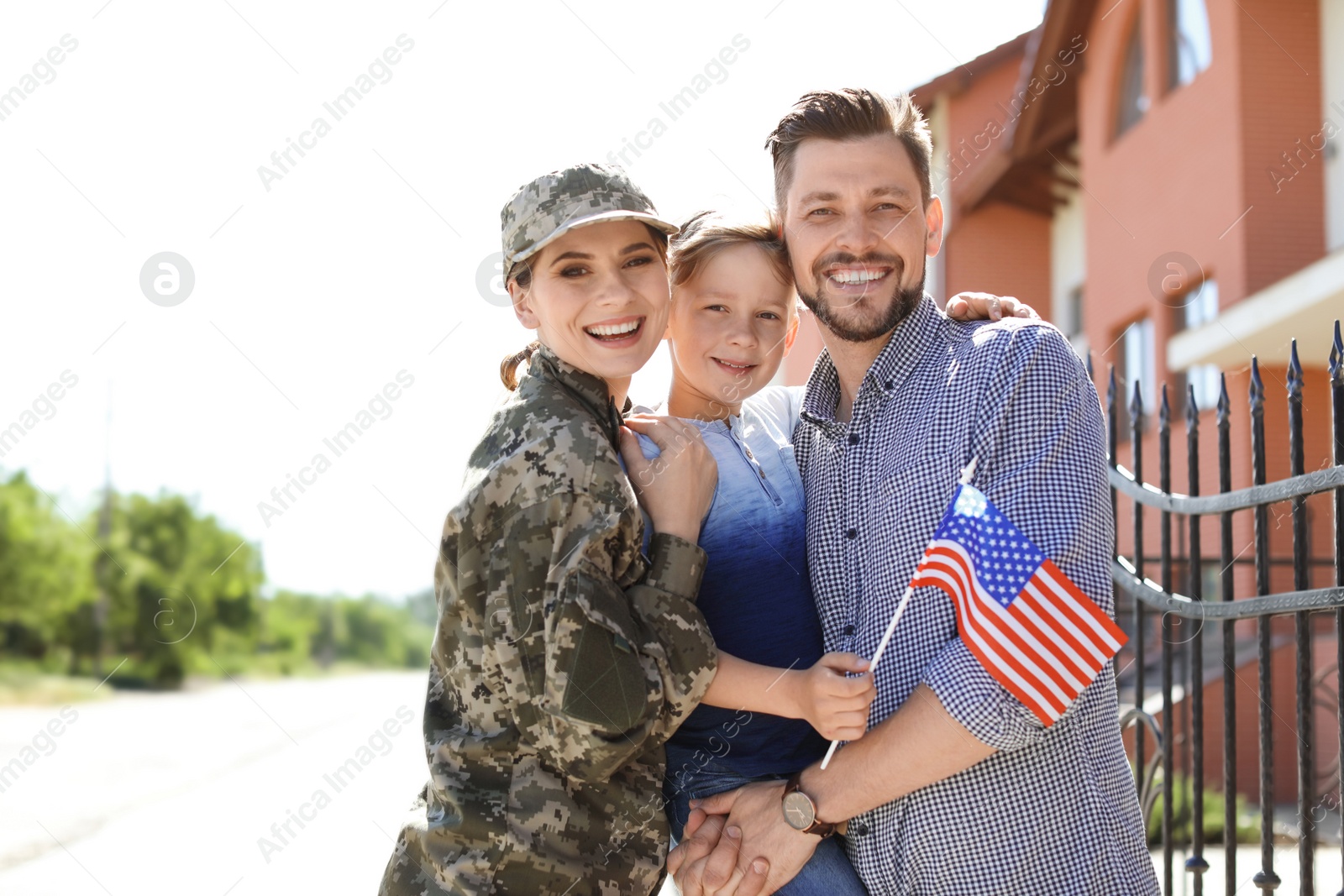 Photo of Female soldier with her family outdoors. Military service