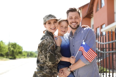 Female soldier with her family outdoors. Military service