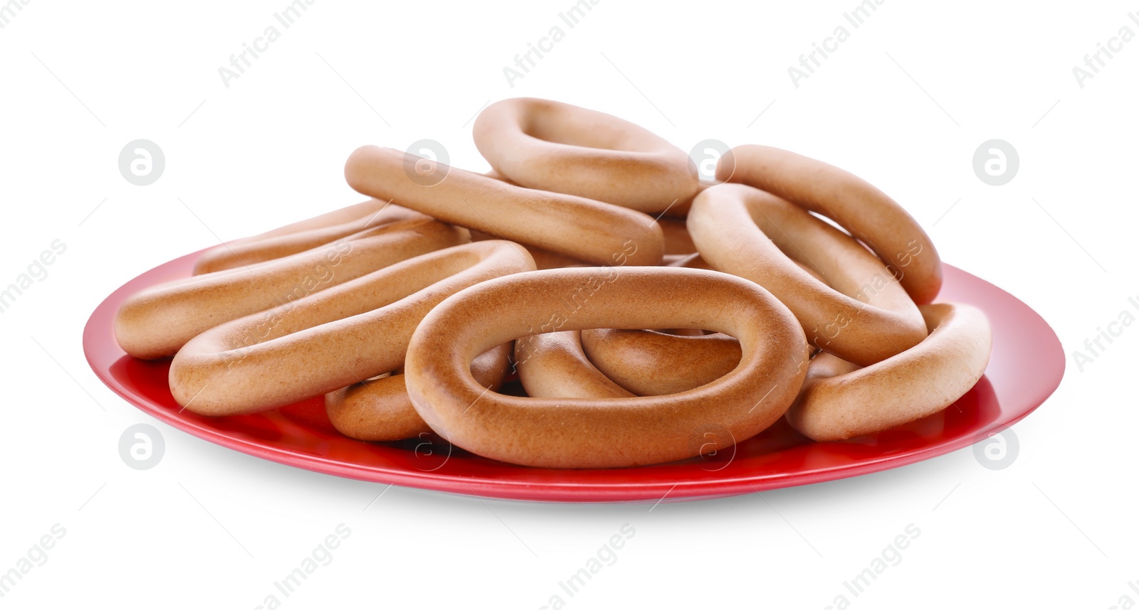 Photo of Plate with tasty dry bagels (sushki) isolated on white, top view