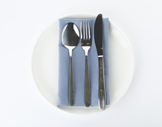 Plate with cutlery and napkin on white background, top view