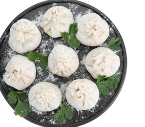 Board with uncooked khinkali (dumplings) and parsley isolated on white, top view. Georgian cuisine