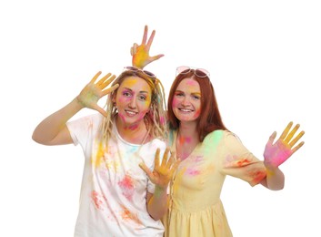 Women covered with colorful powder dyes on white background. Holi festival celebration