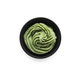 Photo of Bowl with swirl of wasabi paste isolated on white, top view