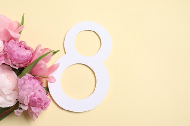 8 March greeting card design with beautiful flowers on light yellow background, top view. Space for text