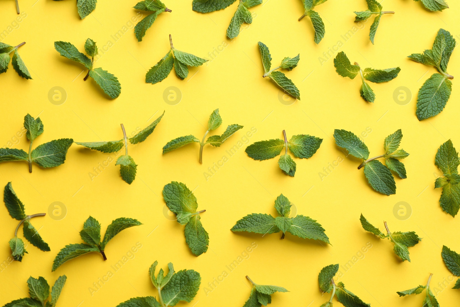 Photo of Fresh mint leaves on yellow background, flat lay