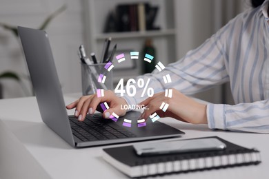 Image of Loading progress. Woman working on laptop at table indoors, closeup