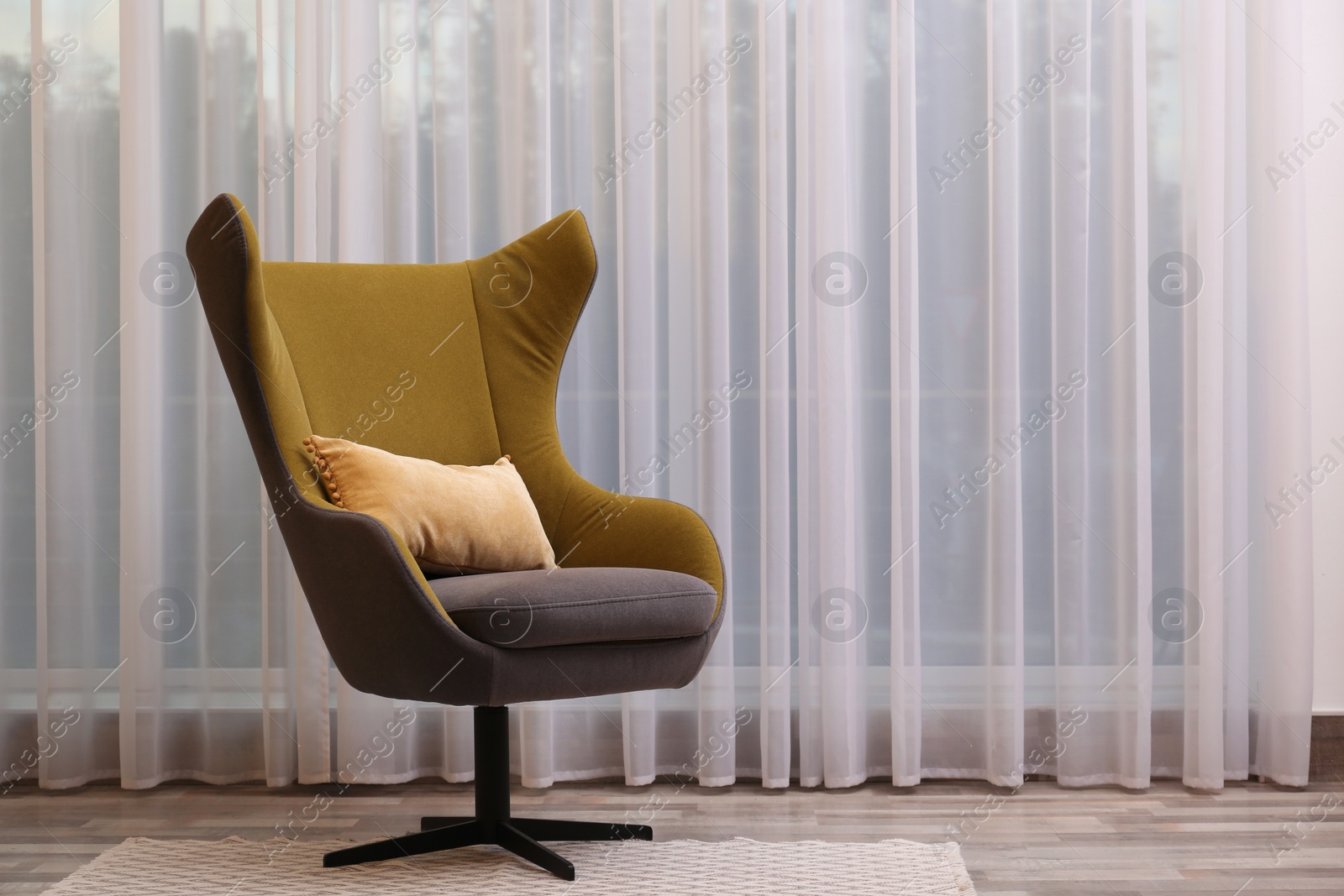 Photo of Comfortable armchair near window in living room, space for text. Interior design