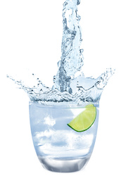 Water splashing out of glass with ice cubes on white background. Refreshing drink