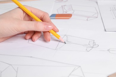 Woman creating packaging design at table, closeup