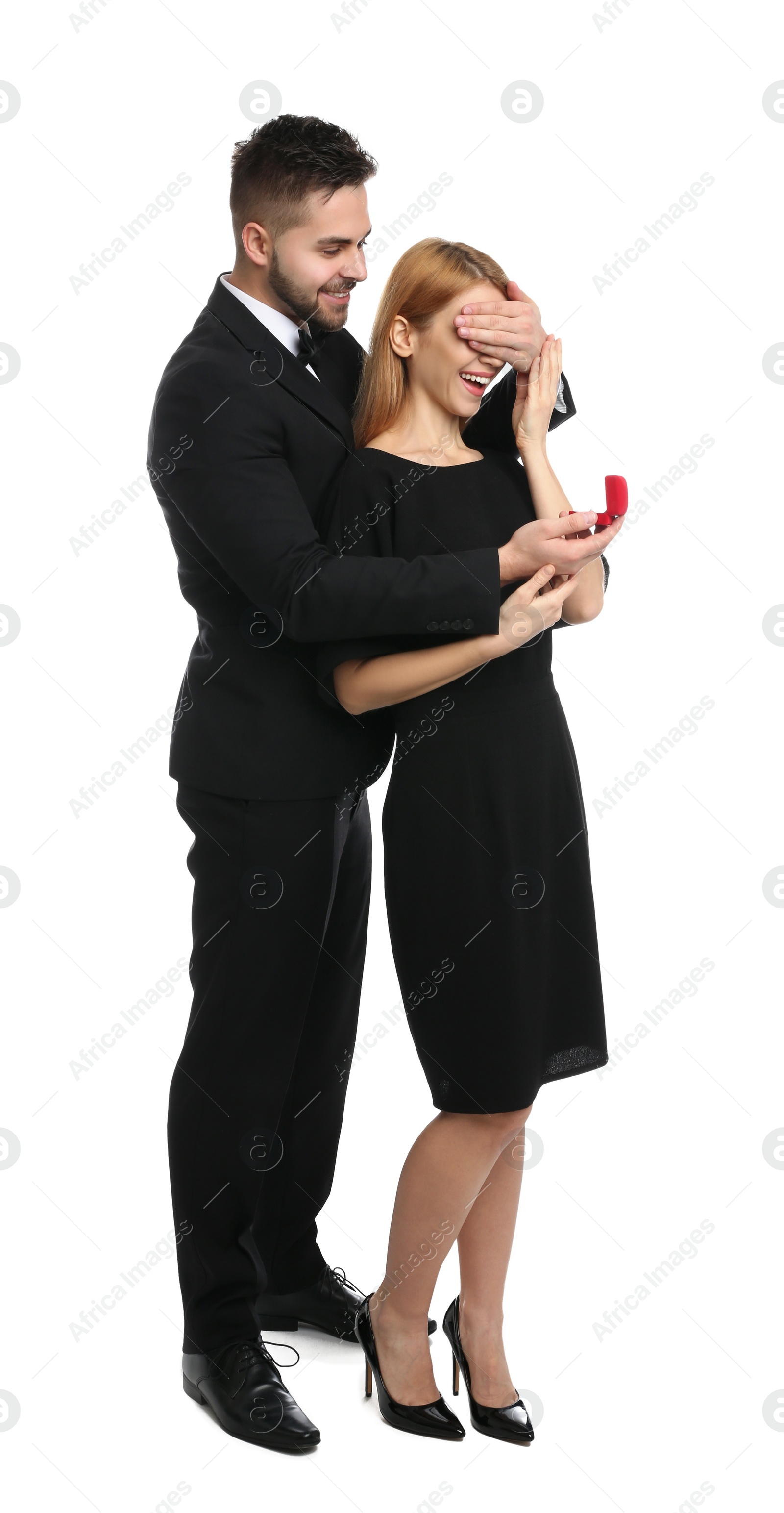 Photo of Man with engagement ring making marriage proposal to girlfriend on white background