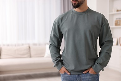 Photo of Man in stylish sweater at home, closeup. Space for text