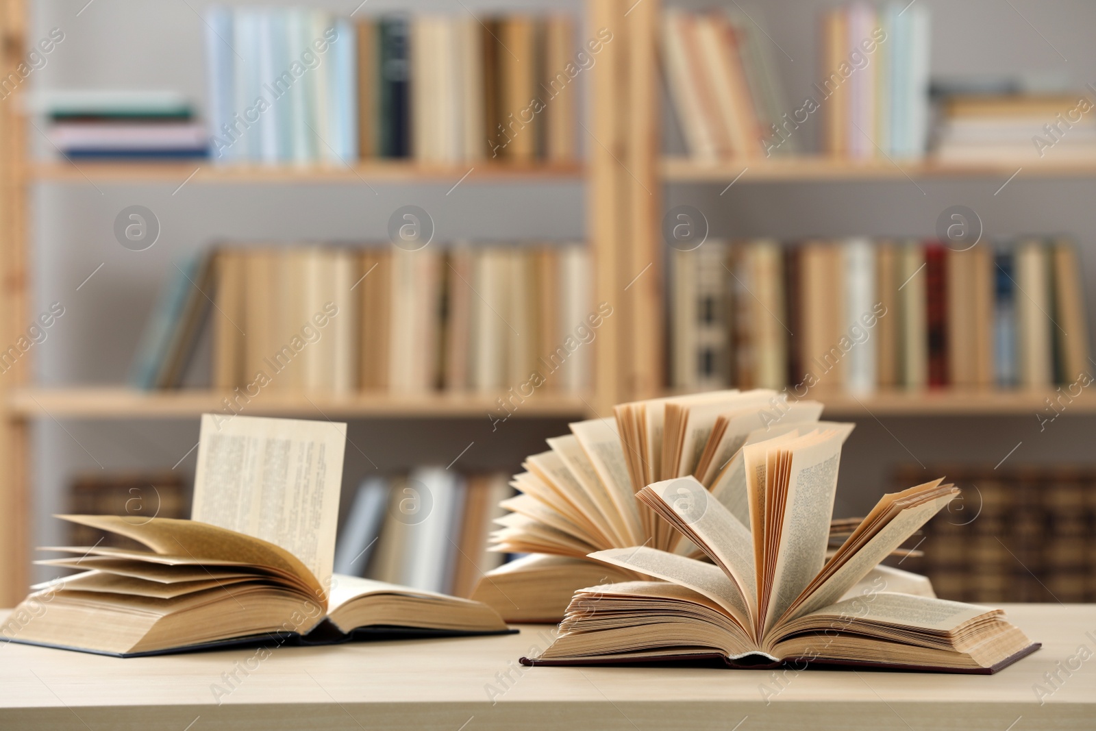 Photo of Open books on light table in library, space for text