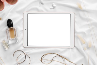 Photo of Flat lay composition with modern tablet on white fabric. Space for text