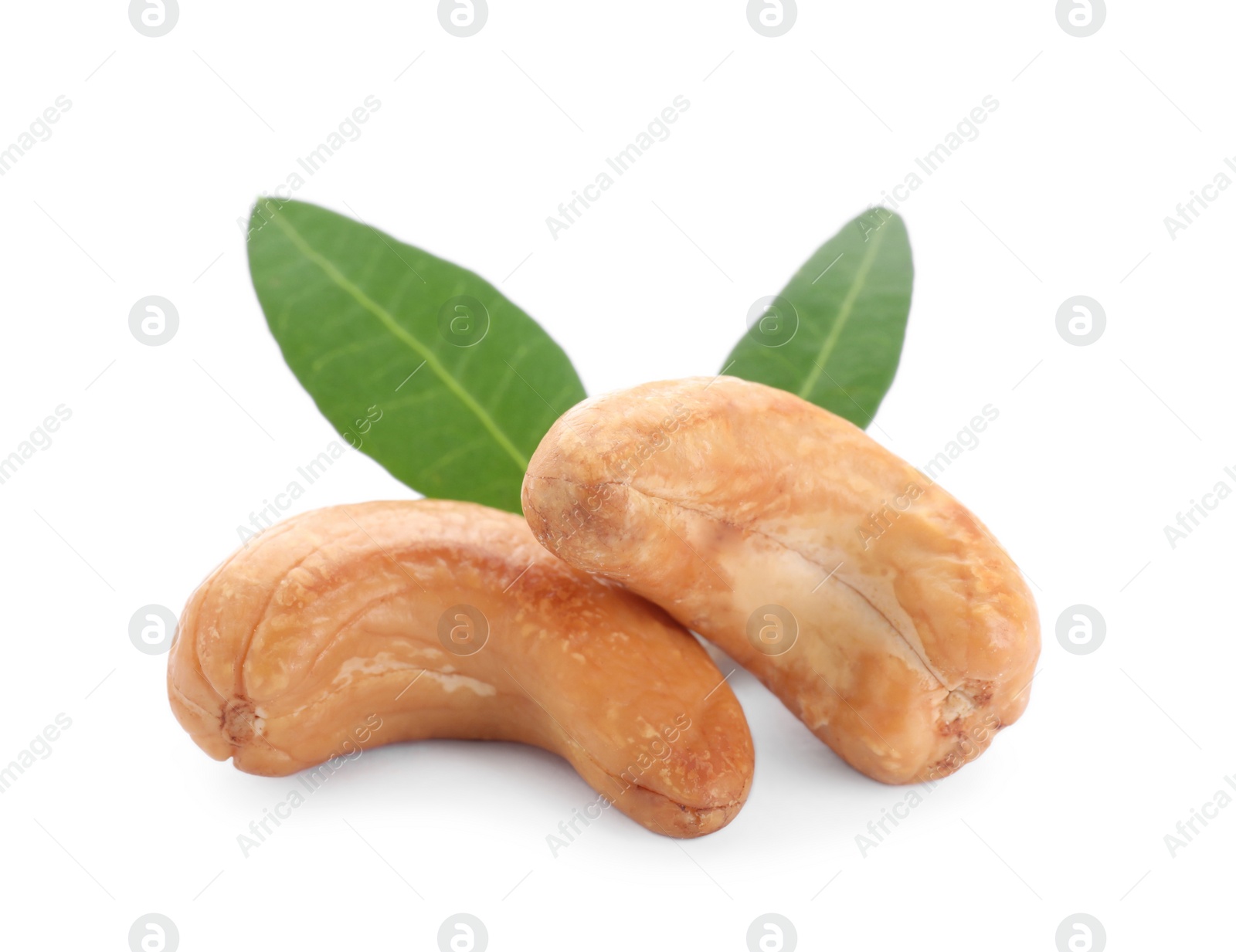 Photo of Tasty organic cashew nuts and green leaves isolated on white