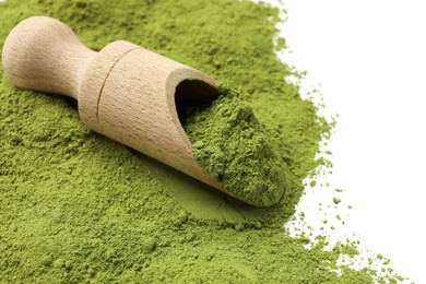 Photo of Green matcha powder and wooden scoop isolated on white