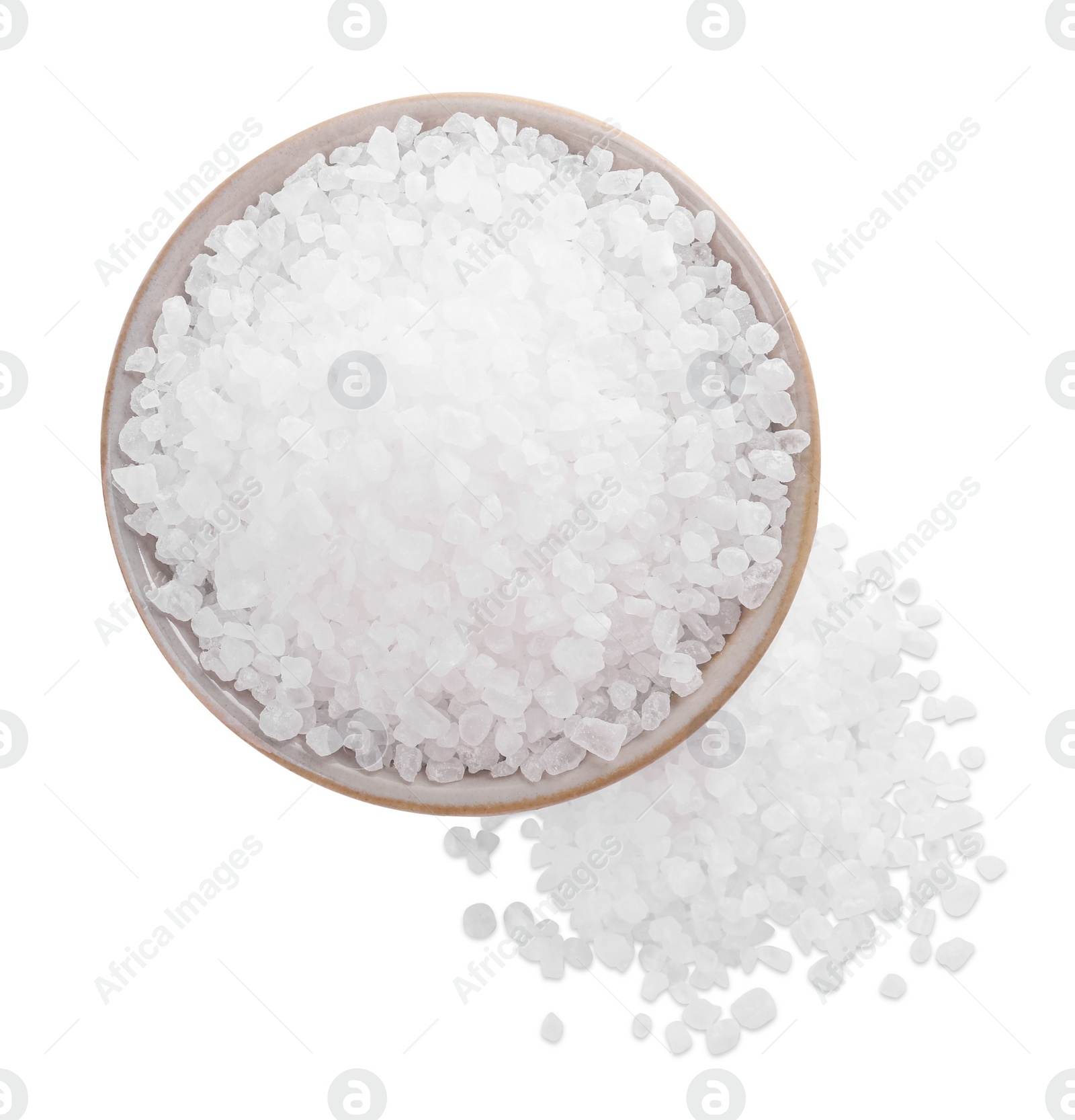 Photo of Ceramic bowl and heap of natural sea salt isolated on white, top view