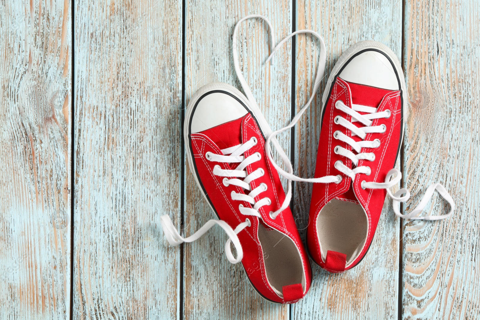 Photo of Pair of stylish shoes with laces on wooden background, flat lay. Space for text