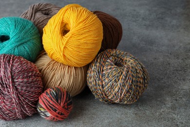 Photo of Many different soft woolen yarns on grey table