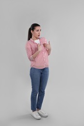 Photo of Emotional woman pointing at herself on grey background