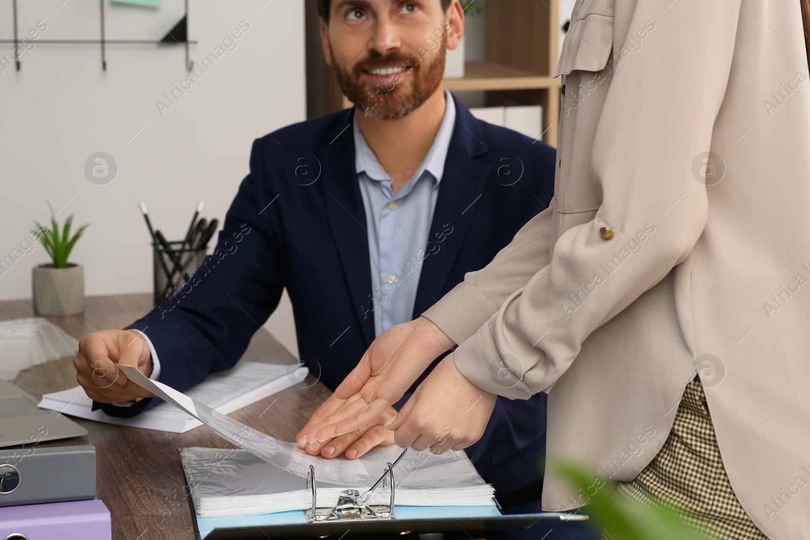 Photo of Businesspeople working together with documents in office