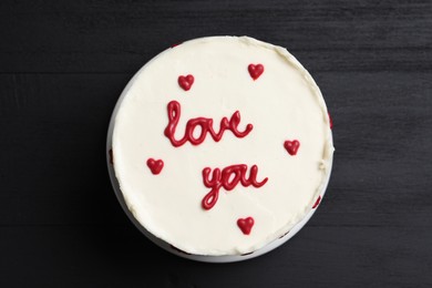 Bento cake with text Love You on black wooden table, top view. St. Valentine's day surprise