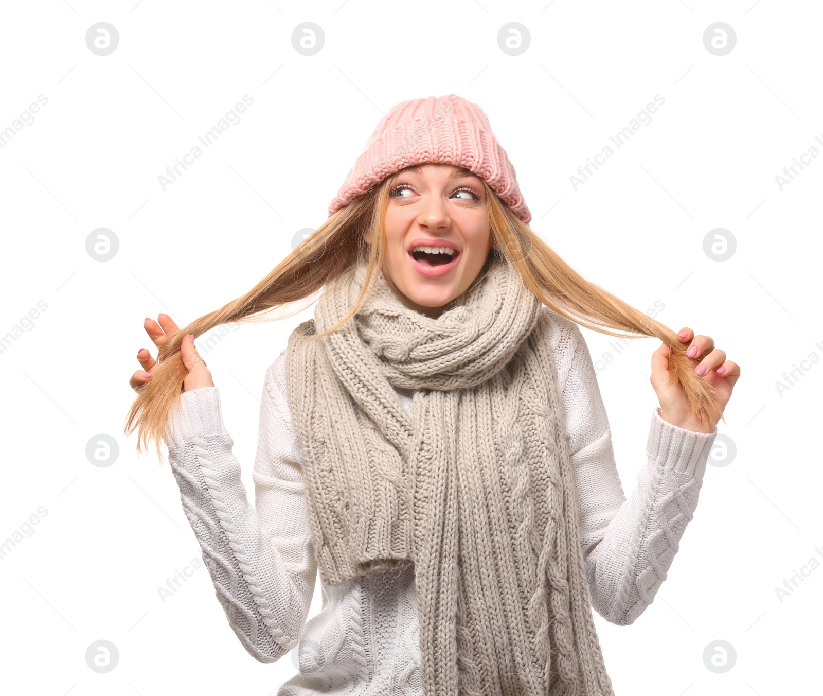 Photo of Portrait of emotional young woman in stylish hat and sweater with scarf on white background. Winter atmosphere