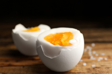 Photo of Tasty boiled chicken eggs on wooden table, closeup