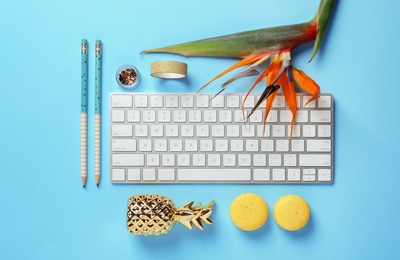 Photo of Creative flat lay composition with tropical flower and computer keyboard on color background