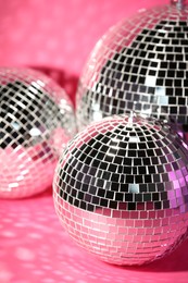 Photo of Many shiny disco balls indoors, toned in pink