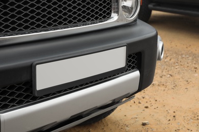 Modern car in desert, closeup of bumper