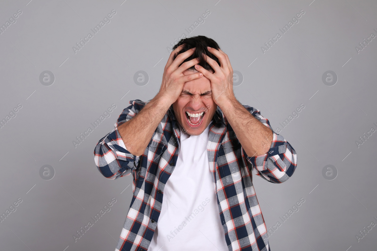 Photo of Portrait of emotional man on light grey background. Personality concept