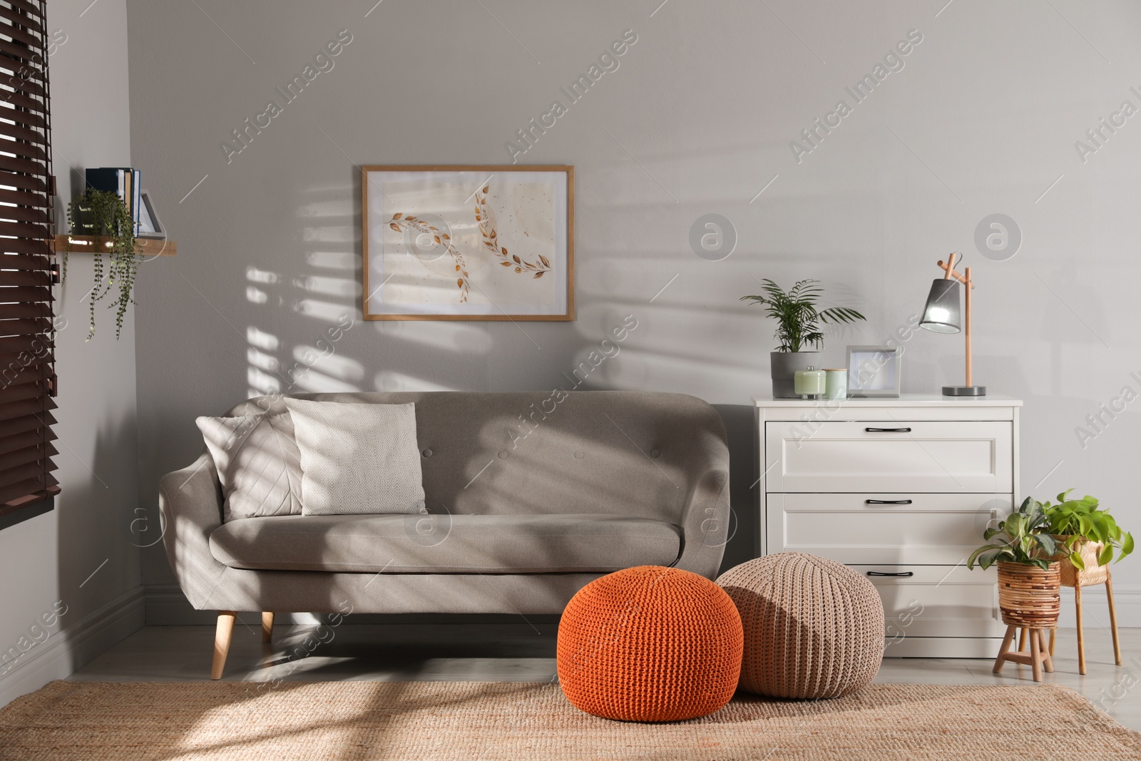 Photo of Stylish knitted poufs and sofa in living room. Home design