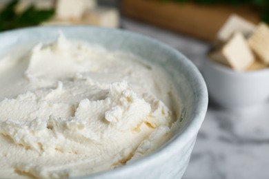 Photo of Delicious tofu cream cheese in bowl on table, closeup view