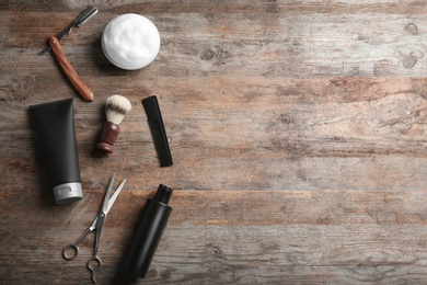 Photo of Flat lay composition with men's cosmetic products on wooden background. Space for design