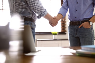 Business partners shaking hands after meeting, closeup