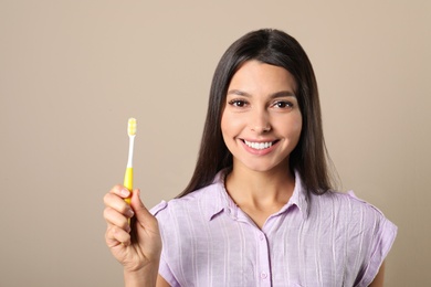 Photo of Young woman with toothbrush on color background. Teeth care
