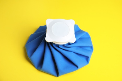 Photo of Ice pack on yellow background. Cold compress