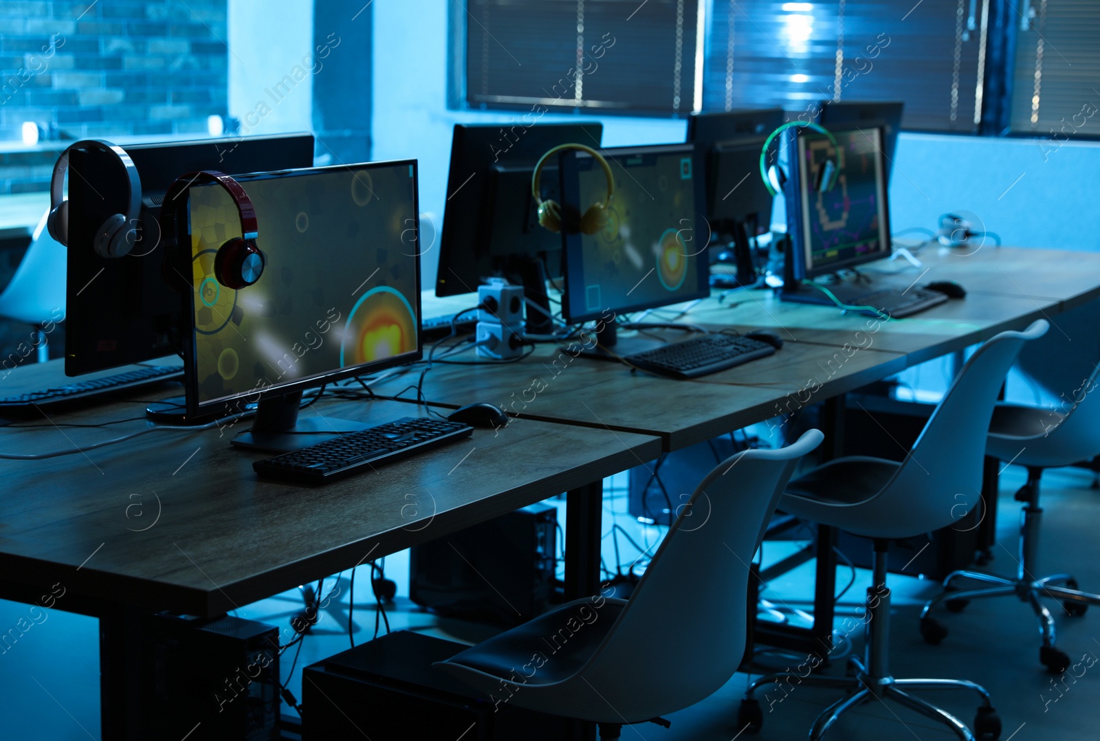 Photo of Internet cafe interior with modern computers. Video game tournament