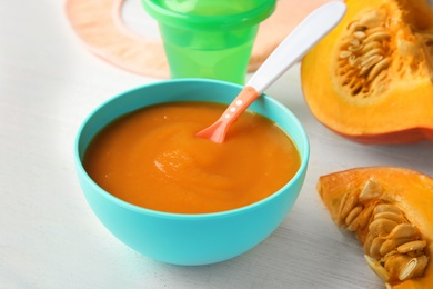 Photo of Bowl of healthy baby food on light table