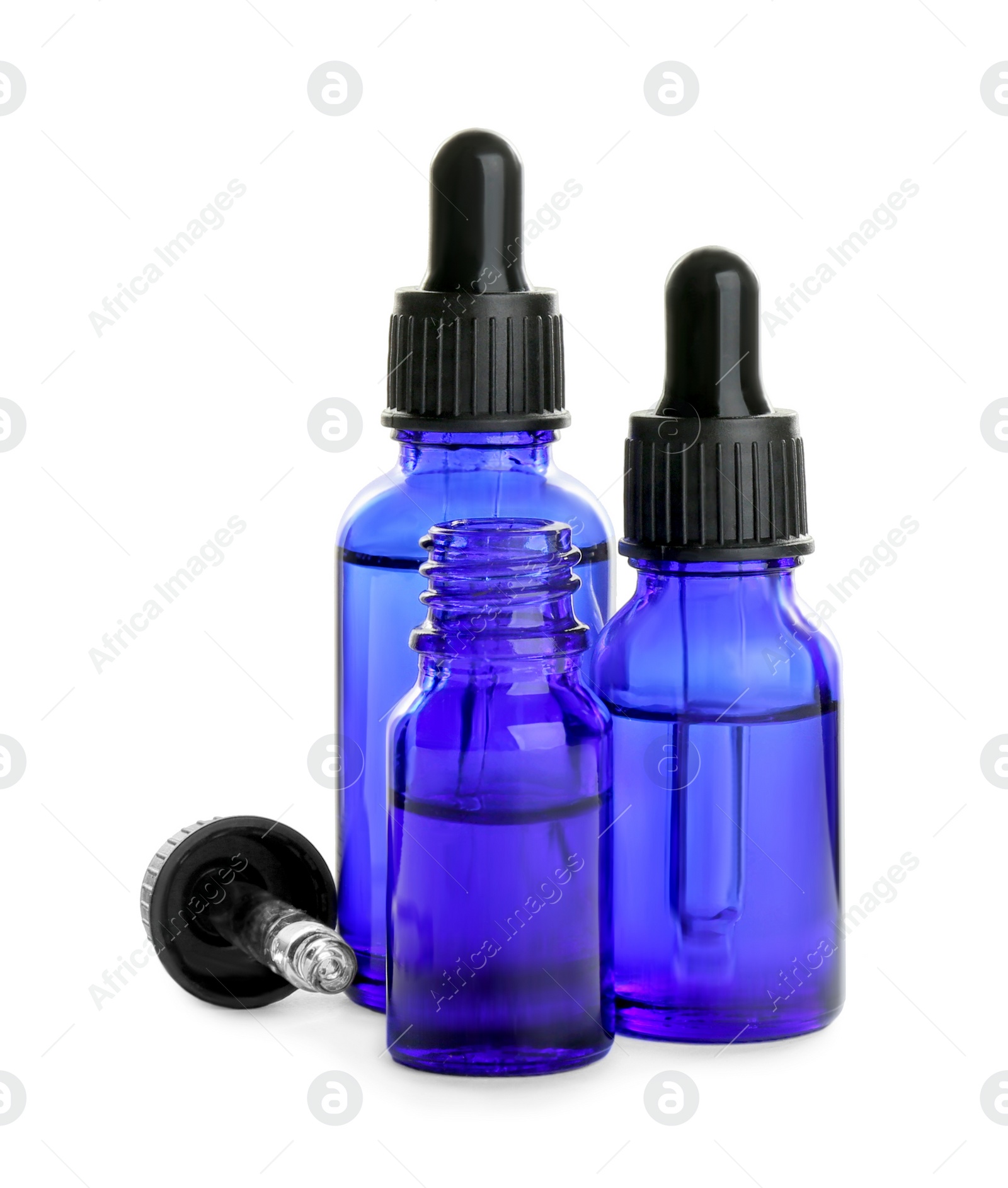 Photo of Little blue bottles with essential oils on white background