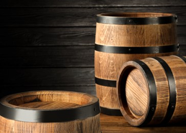 Image of Barrels on wooden background, space for text