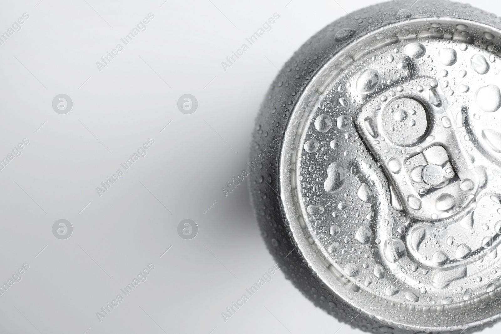 Photo of Wet closed can on white background, top view