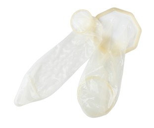 Photo of Unrolled female and male condoms isolated on white, top view. Safe sex