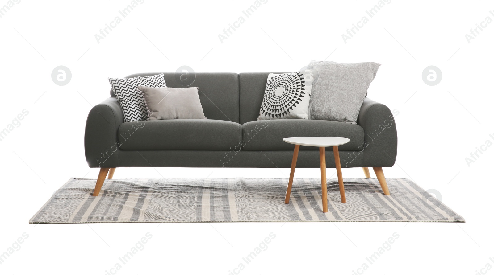 Photo of Comfortable grey sofa with cushions, table and carpet on white background. Furniture for living room interior