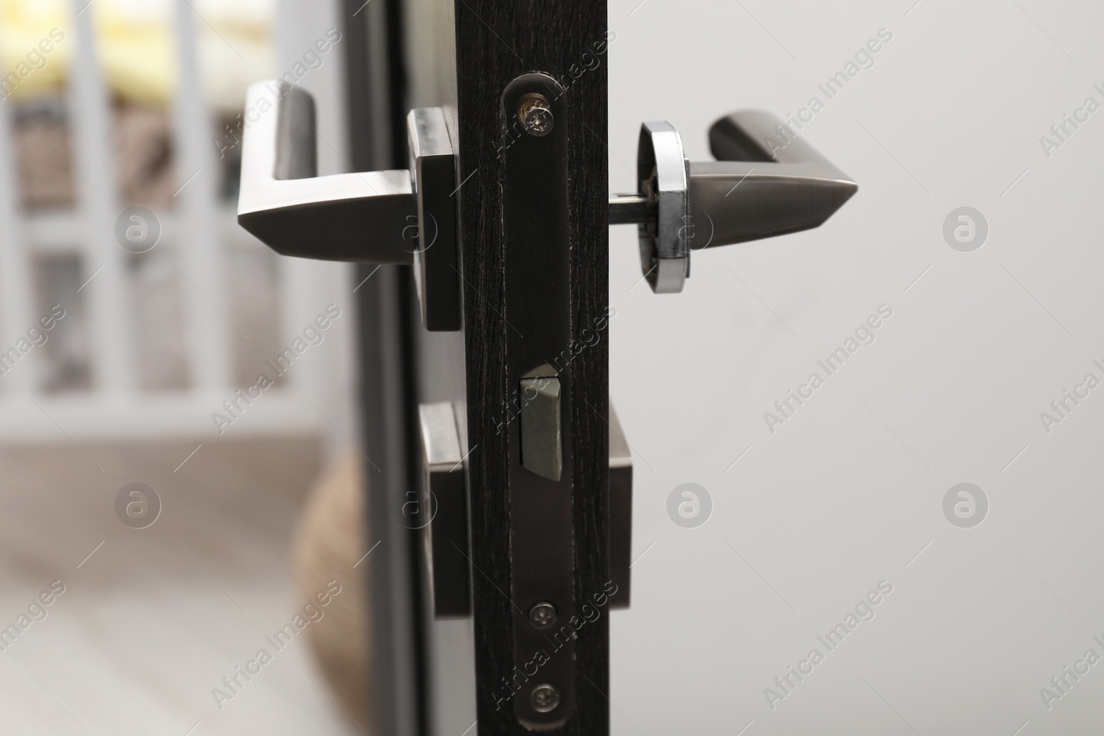 Photo of Wooden door with broken handle indoors, closeup
