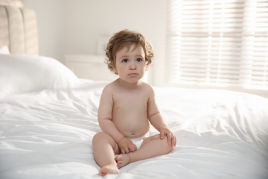 Cute little baby on bed at home