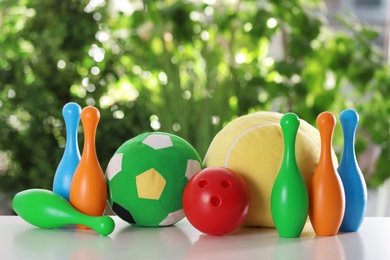 Set of different toys on table against blurred background